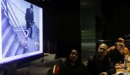 Police and Bureau of Fire officials, and Resorts World representatives watch surveillance video footage showing the gunman who on June 2 stormed into the Resorts World casino and hotel complex, during a press conference in Manila on June 3, 2017. (AFP)