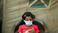 A Yemeni child suspected of being infected with cholera sits outside a makeshift hospital in Sanaa on June 5, 2017.  AFP / MOHAMMED HUWAIS