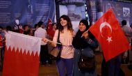 Women pose with Turkish and Qatari flags during a demonstration in favour of Qatar in central Istanbul, Turkey, late June 7, 2017. Reuters/Murad Sezer
