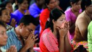Family members of victims from a military plane crash cry during a funeral ceremony in Dawei, Myanmar, yesterday. 
