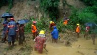 Bangladeshi fire fighters search for bodies after a landslide in Bandarban on June 13, 2017. Heavy monsoon rains have killed at least 46 people in southeast Bangladesh, most of them buried under landslides, authorities said on June 13. / AFP.