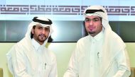 Abdulla Al Yafei (left), QU Student Services and Activities Director and Mohammed Yousef Al Otaibi, QYH Deputy Executive Director during the signing ceremony. 