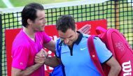 Germany's Tommy Haas (left) comforts Roger Federer after the match.