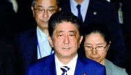 Japanese Prime Minister Shinzo Abe (C) heads for the budget committee of the upper house of parliament in Tokyo on June 16, 2017. Abe was under mounting pressure over allegations that he used his influence to help a friend in a business deal after two off