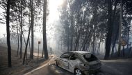 A burned car is seen in the aftermath of a forest fire near Pedrogao Grande, in central Portugal, June 18, 2017. REUTERS/Rafael Marchante