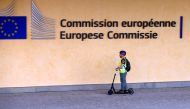 A scooter rider arrives at the EU headquarters as Britain and the EU launch Brexit talks in Brussels, June 19, 2017. REUTERS/Francois Lenoir
