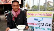 Tuon Tem, 49, holds a bowl with porridge outside of his restaurant in Siem Reap province, Cambodia, June 19, 2017. REUTERS/Stringer.