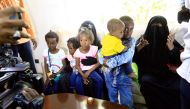 Relatives hug children of Sudanese Islamic State members who operated in Libya, as they arrive at Khartoum airport, Sudan June 20,2017 . REUTERS/Mohamed Nureldin Abdallah.
