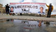 People protest against the kidnapping of Dutch journalists Derk Johannes Bolt and Eugenio Ernest Marie in Bogota, Colombia June 21, 2017. The banner reads: 'Dutch journalists kidnapped, Liberty Now.' REUTERS/Jaime Saldarriaga.