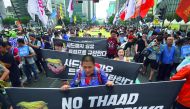 Protesters march towards the US embassy during a rally against the deployment of the US Terminal High Altitude Area Defence (THAAD) system, in Seoul, yesterday.