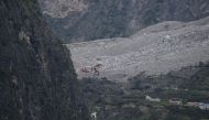 Chinese rescuers search for survivors at a landslide area in the village of Xinmo in Maoxian county, China's Sichuan province on June 25, 2017. AFP / WANG Zhao
