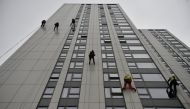 Specialists abseil down the side of Bray Tower to check the cladding, on the Chalcots Estate in north London, Britain, June 27, 2017. Reuters/Hannah McKay