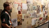 Mike Patterson, owner of historic Harley-Davidson and founder of The Evel Knievel Museum in Topeka, Kansas, surveys the wall of news clippings about the daredevil stunt rider in his Evel Knievel Museum on June 21, 2017. AFP / Beth Lipoff 