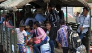 Thailand's military government said it will delay enforcing new labour regulations after thousands of migrant workers fled home to neighbouring countries this week fearing arrest and heavy fines under the new decree. PHOTO: AFP