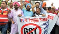 This photo taken on June 30, 2017 shows Indian traders protesting against the forthcoming Goods and Services Tax (GST) during a demonstration outside a tax office in Amritsar. AFP / NARINDER NANU 