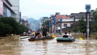 People make their way with boats through a flooded area in Liuzhou, Guangxi province July 2, 2017. — Reuters pic.