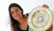 Wimbledon women’s singles champion Marion Bartoli of France holds her trophy in Boulogne-Billancourt near Paris, in this July 10, 2013 file picture.