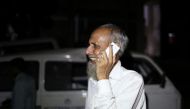 A man, who lost his daughter-in-law, cries while talking on the phone following a deadly boiler blast inside a garment factory in Gazipur, Bangladesh, July 4, 2017. REUTERS/Probal Rashid.