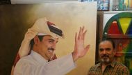 Bilal AlDori with one of his works