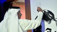 Minister of Transport and Communications H E Jassim bin Saif Al Sulaiti signs on a poster of Emir H H Sheikh Tamim bin Hamad Al Thani during the Graduation Ceremony for Qatar Aeronautical College which took place at QNCC, yesterday. Pic: Baher Amin / The 