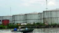 A boat travels down a river near the southeastern oil city of Warri, in Delta state, Nigeria 