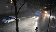 A person drives a vehicle under a heavy rainfall on July 9, 2017 in the 20th district of Paris. Paris subway authorities closed metro stations due to flooding after thunderstorms and heavy rain pounded the French capital, officials said on July 10, 2017. 