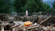 A resident walks across a damaged bridge in a flooded area in Asakura city, Fukuoka prefecture on July 11, 2017. / (AFP PHOTO / JIJI PRESS / STR / Japan OUT / Manila Bulletin).