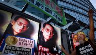 Protesters demonstrate outside the Chinese Foreign Ministry in Hong Kong October 8, 2010 demanding the release of jailed Chinese pro-democracy activist Liu Xiaobo.Chinese characters on the placard reads 