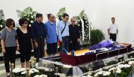 This handout photo provided by the Shenyang Municipal Information Office shows late Nobel laureate Liu Xiaobo's wife Liu Xia (R-in black) and family members standing next to Liu Xiaobo's body at a funeral parlour in the Chinese city of Shenyang, Liaoning 