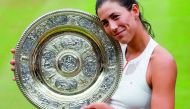 Spain’s Garbine Muguruza poses after she beat US player Venus Williams to win the Wimbledon final.