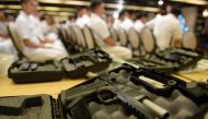 Philippine soldiers are seen past .45 caliber handguns ahead of a handover of some 3,000 units of the weapons to the military, at Malacanang Palace in Manila on July 18, 2017. President Duterte announced plans July 18 to extend martial law in the southern