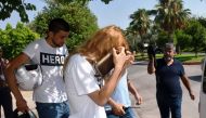 People wearing t-shirts with bearing the word 