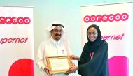 Ooredoo’s Director of PR and Corporate Communications, Manar Khalifa Al Muraikhi, receiving the award from Mohammed Abdulrahman Al Sayed, Best Buddies Qatar Manager of Rehabilitation and Integration Department, at Ooredoo’s headquarters, yesterday.