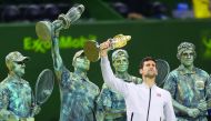 Serbia’s Novak Djokovic poses with the 2017 ExxonMobil Qatar Open trophy at the Khalifa International Tennis Complex in Doha in this file photo. Djokovic will miss the rest of the season due to an elbow injury.