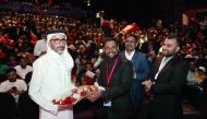Minister of Culture and Sports H E Sheikh Salah bin Ghanim Al Ali being honoured by representatives of the Indian community in Qatar. RIGHT: Audience at the event organised by the Indian community at Qatar National Theatre.