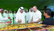 Minister of Municipality and Environment H E Mohammed bin Abdullah Al Rumaihi taking a tour at the dates festival at Souq Waqif, yesterday.
