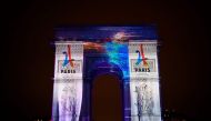 This file photo taken on December 31, 2016 during the New Year celebration shows an image projected on the Arc de Triomphe monument during a laser and 3D video mapping show on the theme of the Paris bid for the 2024 Olympic Games. Los Angeles formally ann