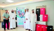 Officials from the Eid Charity at the Long Term Care Unit of HMC as part of the ‘Qatar Draws the Smile’.
