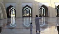 A man and his son stand at Imam Muhammad ibn Abd al-Wahhab Mosque in Doha, Qatar, June 9, 2017 (Reuters / Naseem Zeitoon) 