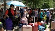 Stranded passengers rest at the departure hall of Jiuzhaigou airport near the remote, mountainous area struck by a deadly earthquake in Sichuan province, China August 9, 2017. REUTERS/Thomas Peter