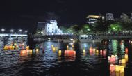 People attend the Peace Message Lantern Floating Ceremony held to console the souls of the A-Bomb victims after the Hiroshima Peace Memorial Ceremony at the Hiroshima Peace Memorial Park on the occasion of the 72nd anniversary of Hiroshima atomic bombing 