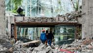 This photo taken on August 10, 2017 shows rescuers walking through the damaged InterContinental Resort Jiuzhai Paradise in Jiuzhaigou in China's southwestern Sichuan province, after an 6.5-magnitude earthquake struck the province late on August 8. AFP