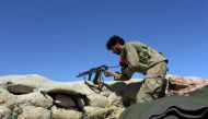 Afghan security forces keep watch near the site of U.S. airstrike on a civilian vehicle in Haska Mina district Nangarhar province on August 12, 2017. (AFP / NOORULLAH SHIRZADA)
