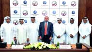 QCB Governor H E Sheikh Abdullah bin Saoud Al Thani (third right), NAMLC Chairman and QCB Deputy Governor Sheikh Fahad Faisal Al Thani (third left), with Daniel L Glaser (centre) of FIN and other officials at the signing ceremony. Pic: Kammutty VP / The P