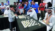 The twelve-year-old Chessmaster, Ieysaa bin Suhayl, goes against officials and guests in a speed chess game at the championships. 