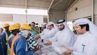 Officials handing over gifts to workers to mark International Humanitarian Day 