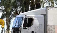 The truck riddled with bullets that was driven by a man through a crowd celebrating Bastille Day being towed away by breakdown lorry in the French Riviera city of Nice, July 15, 2016 (AFP Boris Horvat)