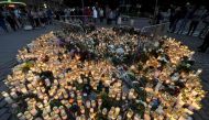 Candles and flowers have been left at the makeshift memorial for the victims of Friday's stabbings at the Turku Market Square, Finland on August 19, 2017.   AFP / Lehtikuva / Vesa Moilanen
