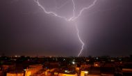 Lightning bolt is seen above a residential neighborhood during rain in Karachi, Pakistan August 21, 2017. REUTERS/Akhtar Soomro.