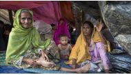 Rohingya people sit on a makeshift shelter near the Bangladesh-Myanmar border as they are being restricted by the Members of Border Guard Bangladesh (BGB) in Gumdum area in Cox's Bazar, Bangladesh on August 28, 2017. / AA.